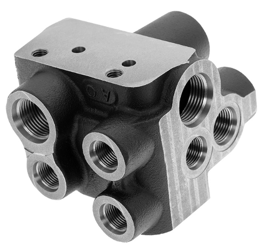 Custom-manufactured valve block with surface treatment for enhanced durability in oil and gas environments