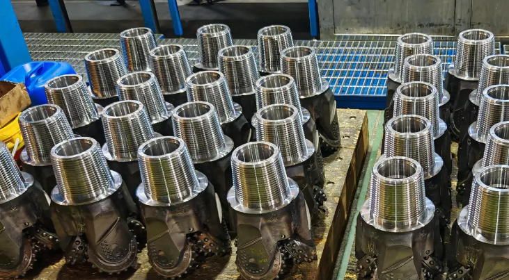 Roller cone drill bit with tungsten carbide inserts for medium-hard to hard rock formations